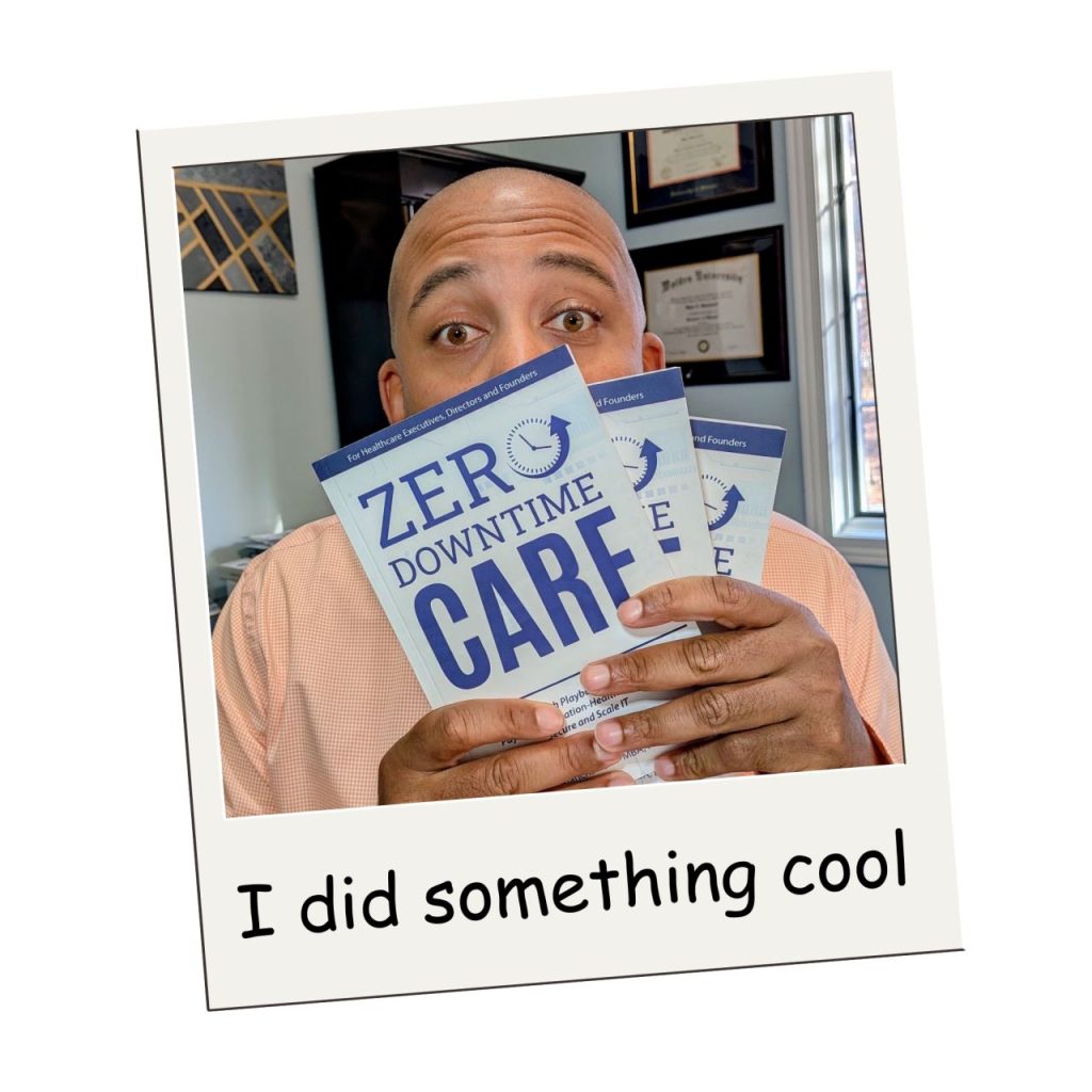 Wylie holding copies of his book, Zero-Downtime Care